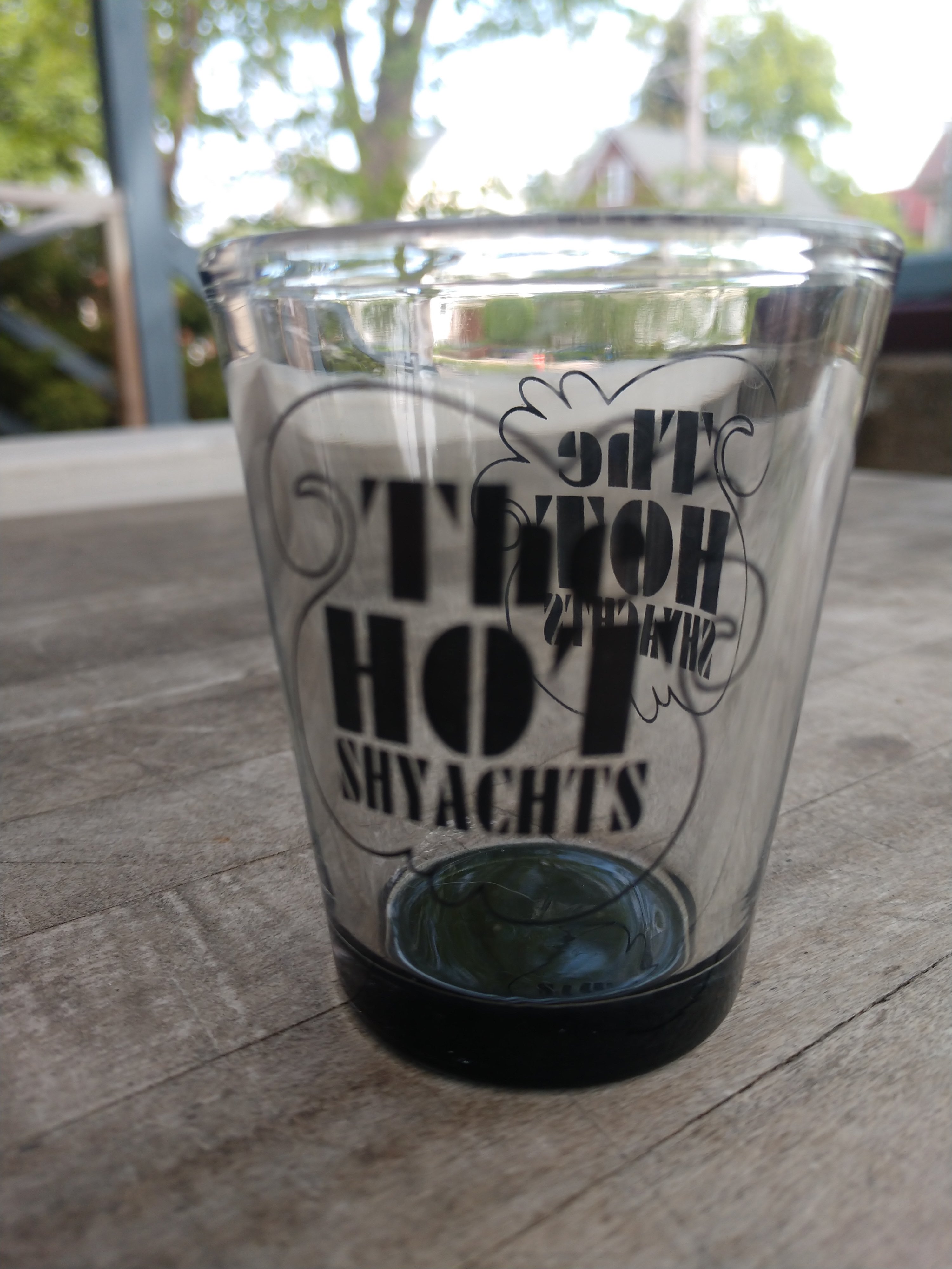 Photo of clear shotglass with black Hot ShYachts boat logo